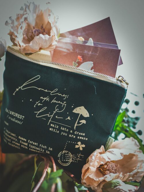 Forest-themed makeup bag with gold zipper, ideal for travel essentials.|Forest themed small makeup bag with gold zipper and green canvas material.|Makeup Bag - Forest, green canvas with gold zipper, holds small items.|Green canvas makeup bag with forest design and gold zipper.