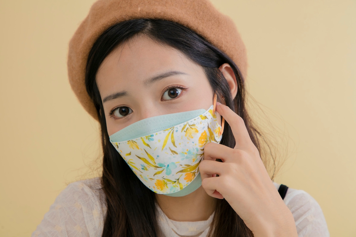 KF94 Medical Facemask in Feverfew Dream design worn by a person.