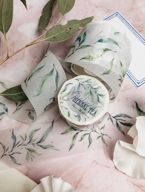 Greenish herbal tea washi tape with leaf designs on a pink background.