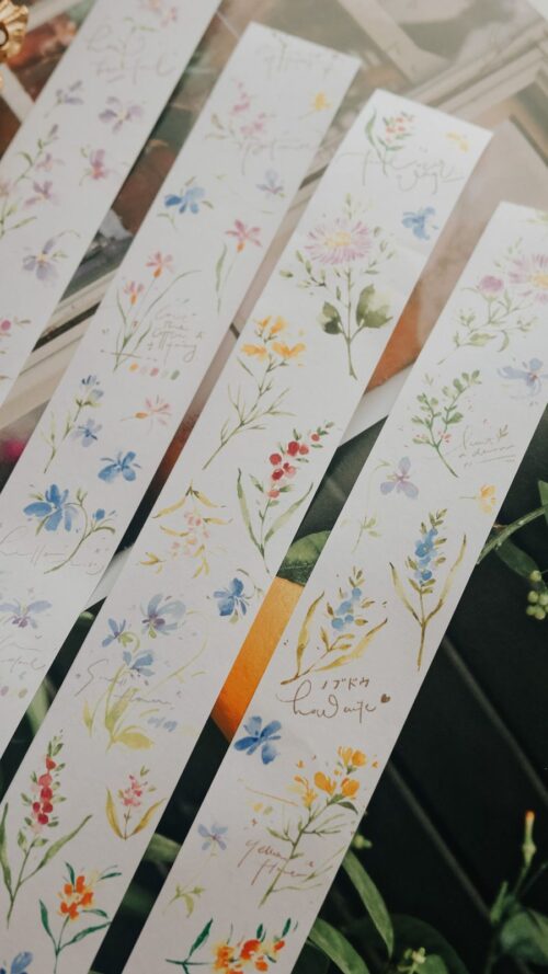 Floral Washitape strips on a table for crafting.