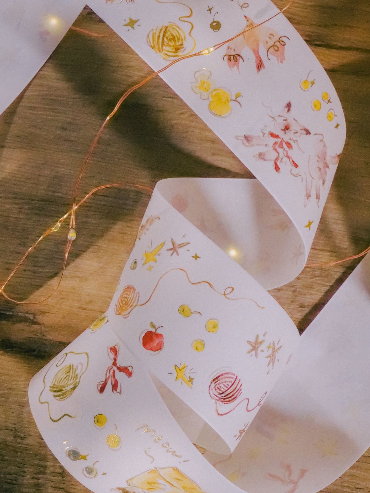 Starry Night-themed kiss-cut washi tape with matte gold foil on a wooden surface.