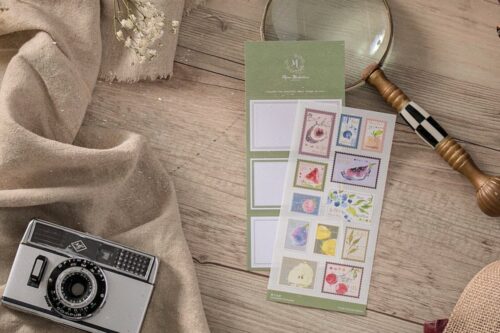 Sheet of colorful fruit salad stamp stickers on a wooden table.