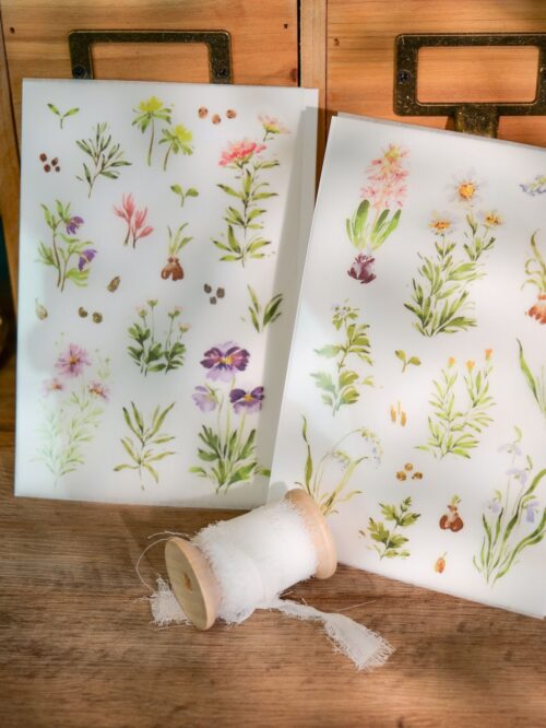 Two sheets of floral transfer stickers with various seasonal blooms.