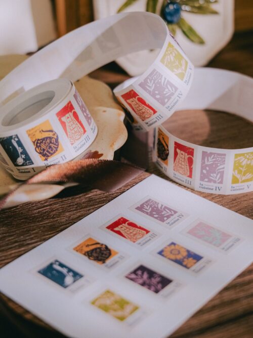 The Gallery Label sticker roll with colorful designs on writable paper.