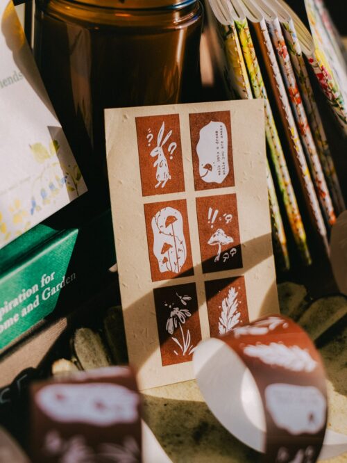 Label sticker roll with Wonderland Rabbits design and mushrooms.