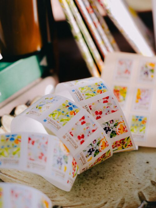 Roll of Luminous label stickers with watercolor designs and vibrant colors.