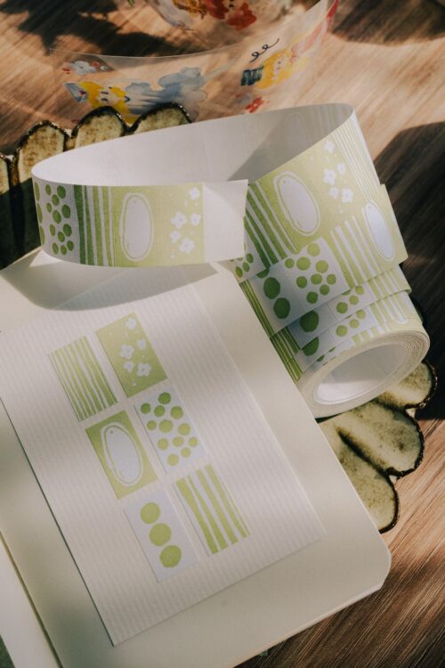 Green PaperNote Sticker Label Roll with 500 writable labels.