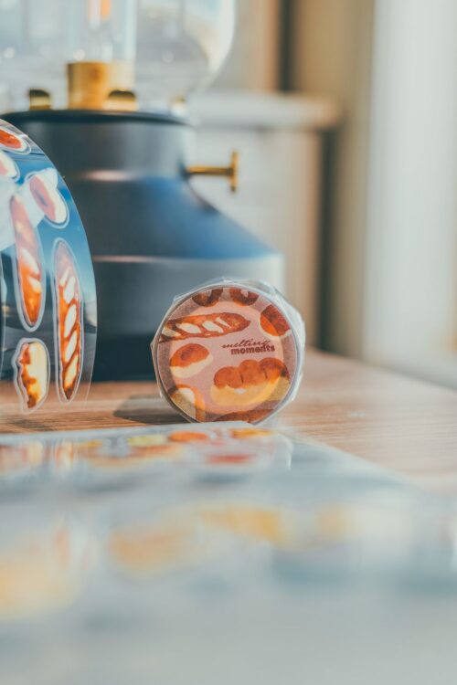 Melting Moments Glossy PET tape with kisscut bakery design on wooden table.