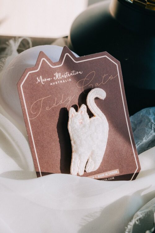 Snow White embroidered pin with fluffy coat and silver pin on display.